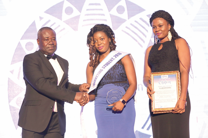 Mr Samuel Tenkorang (left), Marketing Manager of NTHC, presenting the marketing student of the year 2016 award to Ms Lorlornyo Nuworsu , Clients Relations Officer, NHIA.