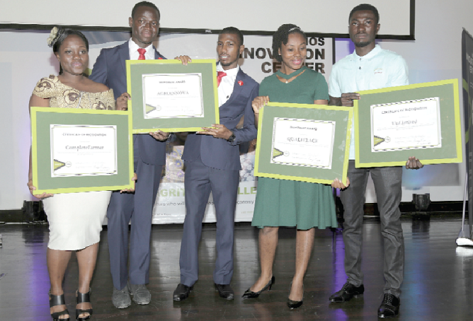 Representatives of four winning business teams displaying their certificates