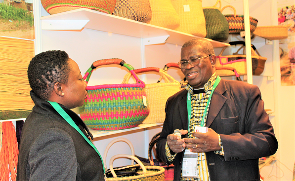 Mr Akpenyo (right) speaking to Daily Graphic reporter, Ms Della Russel Ocloo at the fair.