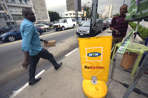 A man passes an MTN board in Lagos, Nigeria. Picture: AFP PHOTO/PIUS UTOMI EKPEI