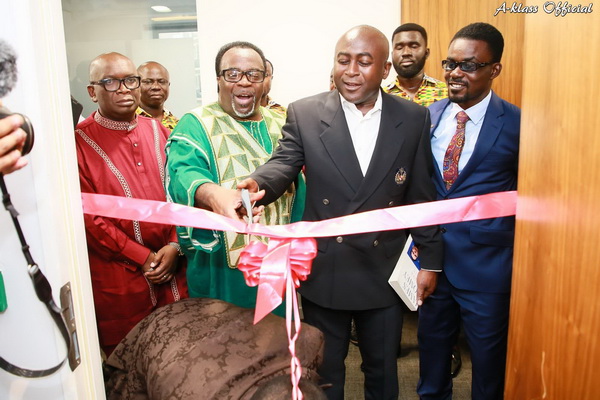 Mr Mensah (right) joining other dignateries to cut the tape to open the London branch of Menzgold