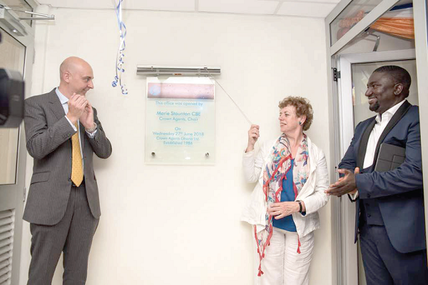 Ferguy Drake (left) and Mr Jourade Quartey (right) together with the Board Chiarperson, Marie Staunton, unveiling a plaque to open the new office