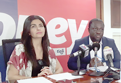 From right: Mr Edmund Barwuah, Director, AirtelTigo Money, addressing the media. Looking on is Ms Roshi Motman, CEO, AirtelTigo