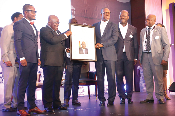 Mr Edward Effah (3rd right), Group CEO, Fidelity Group, presenting an award to President Akufo-Addo for his contribution to the country as the Chief CEO at the 3rd CEO'S Summit in Accra