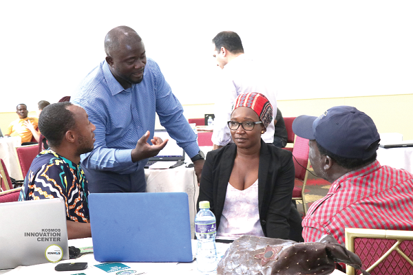 Mr Benjamin Gyan-Kesse, KIC Programme Manager, interacting with some entreprenuers