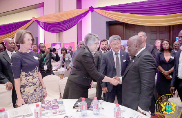 President Akufo-Addo interacting with a guest. With them is Ms Natalia Koliadina (left)