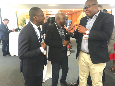 Mr Egbert Faibille interacting with Dr Amin Adams after the presentations. With them is Mr Lawrence Apaalse (middle), Chief Director, Ministry of Energy