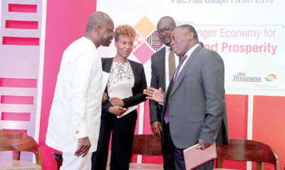 Mr Alhassan Andani (right), CEO, Stanbic Bank, Ghana interacting with Mr Ken Ofori-Atta (left) and other panel discussants after the forum.