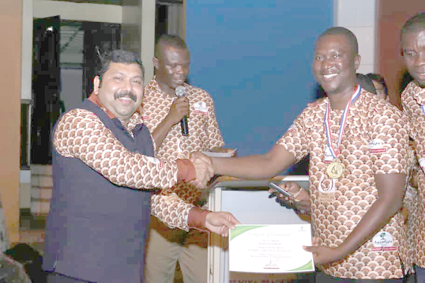  The Managing Director, Nyonkopa Cocoa Buying Company Limited, Dr Joshy Varkey (left) presenting the Best Employee award to Mr David Koomson (right)