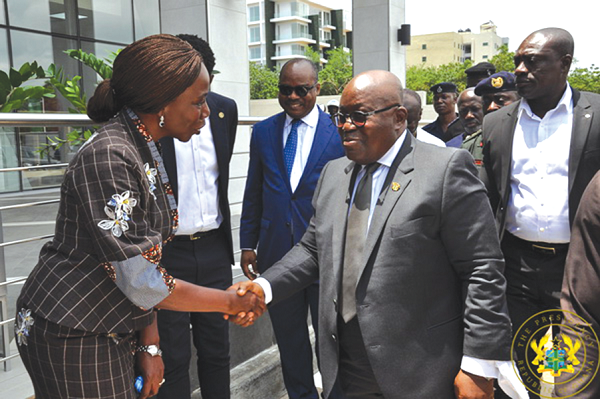 Mrs Mansa Nettey, CEO of Stanchart Ghana, in a handshake with President Nana Addo Dankwa. Looking on is the Governer, BoG, Dr Ernest Addison