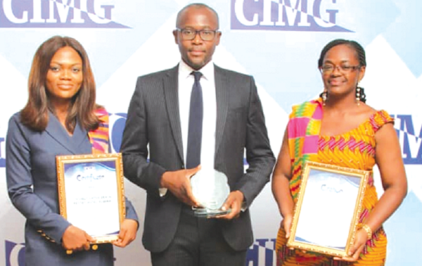  Mr Victor Opoku Minta (middle); Ms Stella Opeku (right), Manager, Bridge House; Ms Anne Arthur (left), Front Office Manager displaying the awards won at the CIMG event