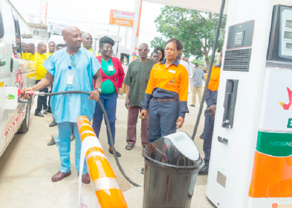 Mr Emmanuel Pobee, Managing Director, Radiance Petroleum Limited, dispensing fuel at the newly opened Darkuman Service Station