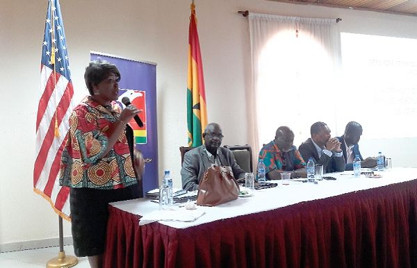 Madam Assam (standing) addressing delegates at the meeting