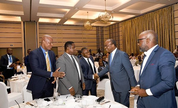  Mr Alhassan Andani (2nd right), MD, Stanbic Bank exchanging pleasantries with Dr Ernest Addison (right), Governor of BoG. Looking on are Mr Ato Afful (left), MD of GCGL and Prof. Peter Quartey of ISSER. Picture: EBOW HANSON