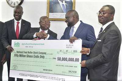 Dr John Kofi Mensah (2nd right) presenting the cheque to Alhaji Hanan Abdul-Wahab (2nd right). With them is Mr William Agyapong Quaittoo (left), the Member of Parliament for Akyem Oda