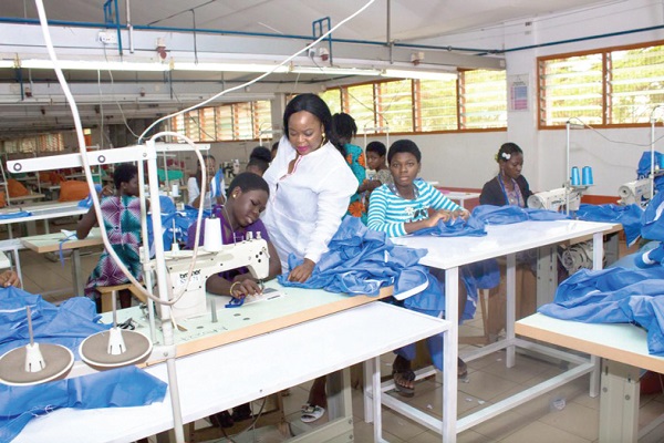  Ms Catherine Noble Anowah (standing) assisting a trainee during a practical learning session