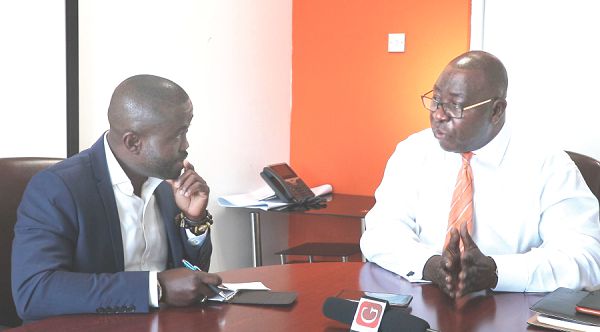 Mr Eric Nipah (right) explaining issues about the developments within the microfinance sector to Mr Charles Benoni Okine, Deputy Editor of the Graphic Business