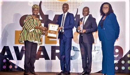 Mr Prosper Amanquandoh (left) of World Energy Council Ghana presenting a citation to Mr Joshua Awutey, Retail Audit Officer, PETROSOL, while Mr Michael Bozumbil (second right) CEO of PETROSOL and Mrs Lawrencia Himans (right), Head of Finance & Planning of Petrosol look on   