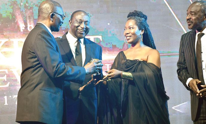 Mr Alan Kyerematen being assisted by Dr Afua Asabea Asare to present the Exporter of the Year 2018 Award to Mr Dan Akyeampong (left), Managing Director of Volta Aluminum Company Limited. Pictures: EBOW HANSON   