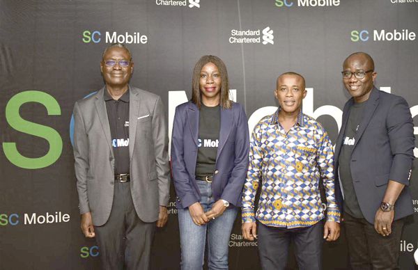 Dr. Emmanuel Oteng Kumah (left), Board Chairman, Stanchart, Mrs Mansa Nettey (2nd left), Dr Settor Amediku  (2nd right) and Mr Henry Baye (right), Executive  Director and Head of Retail Banking after the launch of the Mobile App