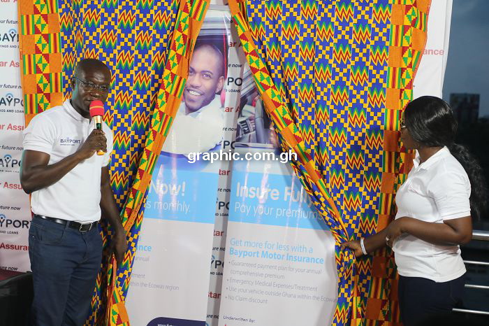 The Chief Commercial Officer at Bayport, Mr Sam Donkor (left) with the Head of Bancassurance at the Star Assurance, Rev. Bridgette Opoku-Sarkodie unveiling the policy during the launch 