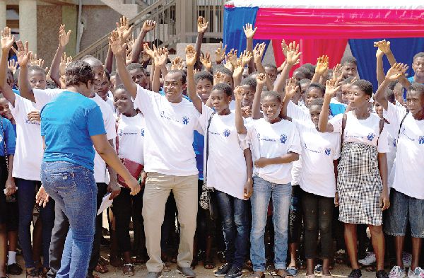 Mr Joseph Garti (6th right), the Chief Executive Officer of HCCUL with some schoolchildren at the programme 