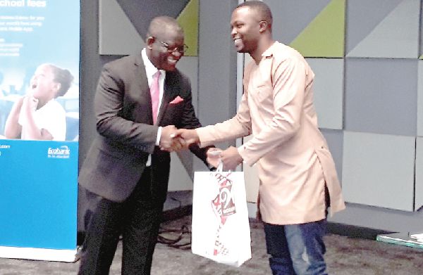 Mr Daniel Sackey (2nd right) presenting the sponsorship package to a beneficiary