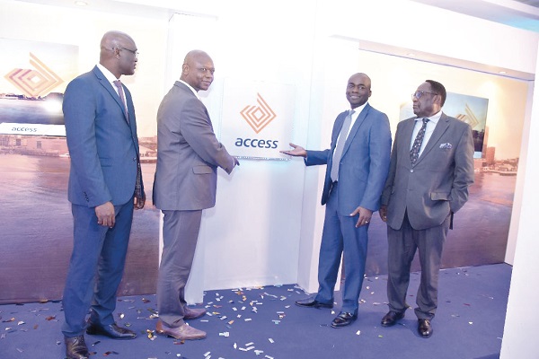 Mr Olumide Olatunji (2nd right) joined by Mr Kofi Awankwa (2nd left), Lead and Head of Examinations, Access Bank, Mr Philip Danso (left), Head of Licensing, BoG and Mr D.K. Mensah, CEO of Ghana Association of Bankers, to unveil the new logo