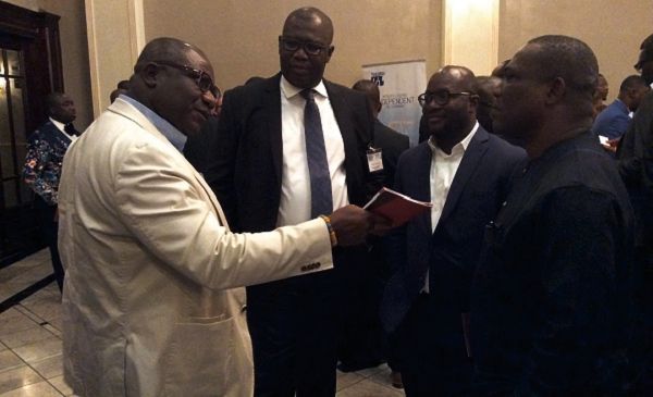  Mr Egbert Faibile (2nd left), CEO, Petroleum Commission, interacting with other dignitaries after the forum