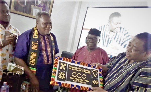   Nana Apiagyei Dankawoso I (right) presenting a citation to Dr Kwaku Oteng (left)