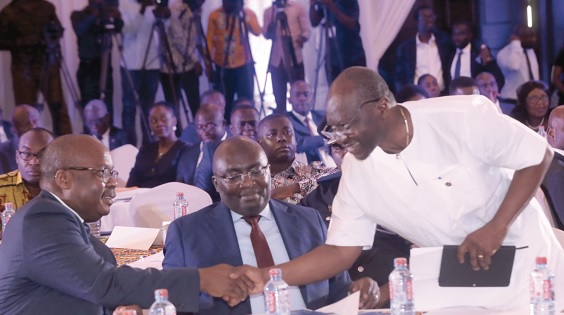  Mr Ken Ofori-Atta (right) shaking hands with Dr Ernest Addison as Vice-President Dr Bawumia looks on at the ceremony