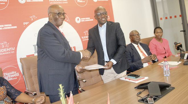  Dr Andrews Arkutu  (left) exchanging the signed documents with Mr Emmanuel Mokobi Aryee. With them is Prof. Agyemang Badu Akosa (right)