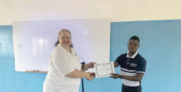 Mr Dennis Asante (right), a beneficiary receiving a certificate from Mrs Susan Comfort (left), a facilitator