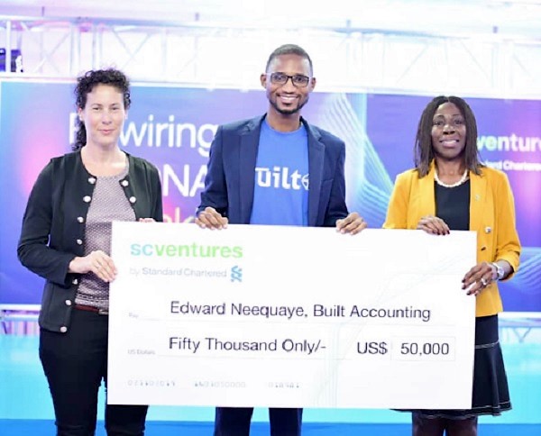  Mr Edward Neequaye (middle) displaying his dummy cheque. With him are Ms Mansa Nettey (right) and Claudia Marcusson from SC Ventures 