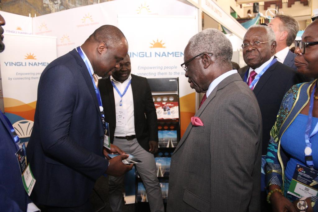 Mr Yaw Osafo-Maafo, Senior Minister, interacting with Mr Firmin Nkaleu Ngassam (left), Managing Director, Yingli Namene West Africa, after the opening ceremony of the 5th Renewable Energy Fair in Accra