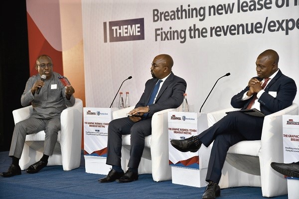 Mr Kofi Bentil (left) making a contribution during the meeting. With him are Mr Albert Touna Mama (middle), IMF resident representative and Mr Abeku Gyan-Quansah