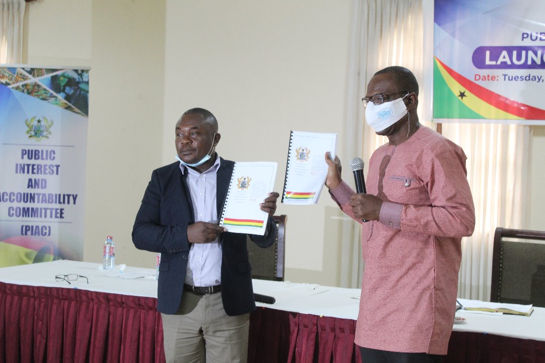 Mr Noble Wadzah (left) and Dr Roland Affail Monney launching the 2019 PIAC report in Accra 