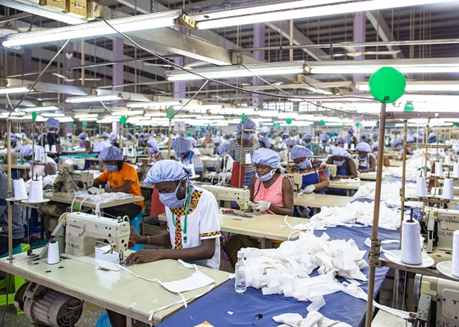 Workers assemble personal protective equipment for frontline health staff at a factory in Accra commissioned by the government. Photo by Nipah Dennis/AFP via Getty Images