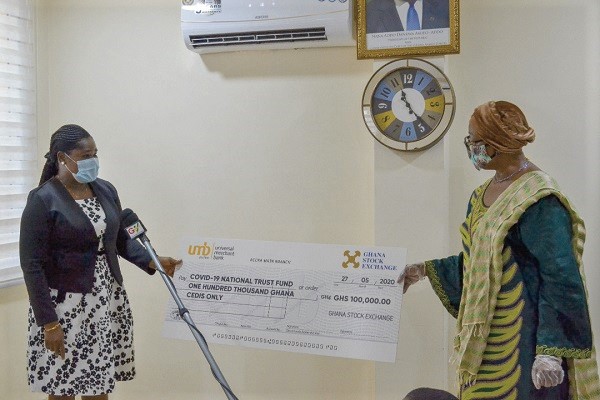 Mrs Diana Okine (left) presenting the dummy cheque to Justice Sophia Akuffo, the chairperson of the Trustees of the fund