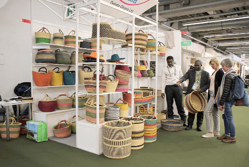 Mr Akpenyo (in suit) explaining some aspects of the baskets to some buyers at the trade fair. Picture: DELLA RUSSEL OCLOO