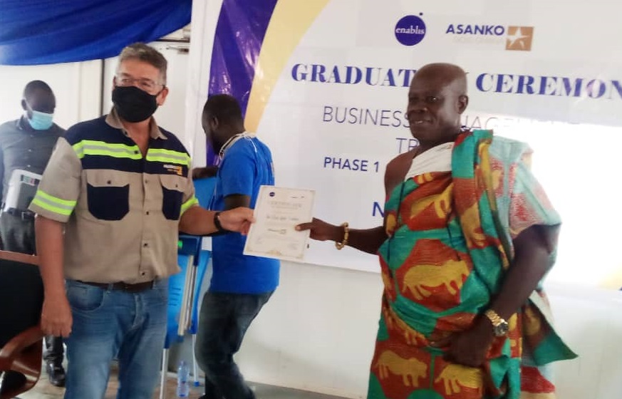 The MD of Asanko (left) presenting a certificate to one of the graduands, Nana Adusei Kwadampin II of Ike Don Links Ventures.