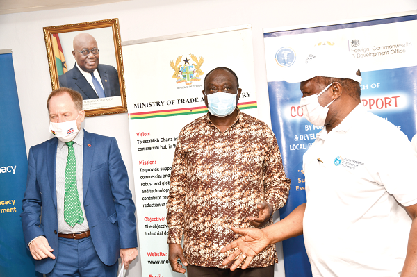  Mr Alan Kyerematen interacting with Mr Harrison K. Abutiate (right), the Chairman of the Ghana National Chamber of Pharmacy, and Mr Philip Smith (left), Development Director of FCDO, during the launch of the COVID-19 support for the local pharmaceutical sector in Ghana. Picture: EBOW HANSON