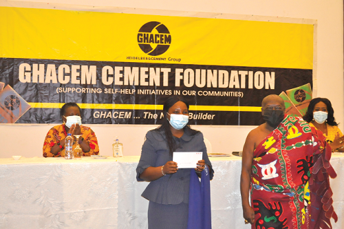 Ehunabobrim Prah Agyensaim VI (right) with a beneficiary who received her cement allocation letter