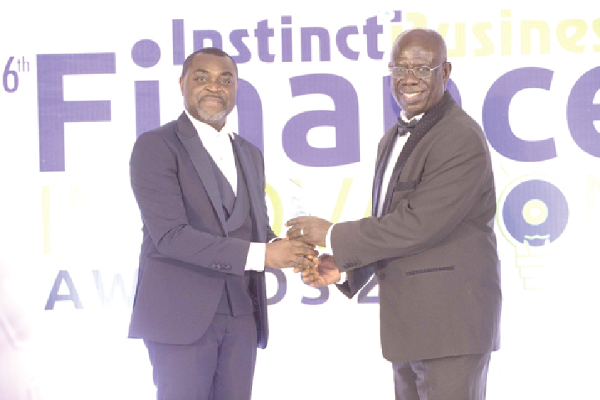 Mr Akin Naphtal (left), CEO, InstinctWave, presenting the award for 2020 Pensions Personality to Mr Hayford Atta Krufi, CEO, NPRA, at the awards night in Accra