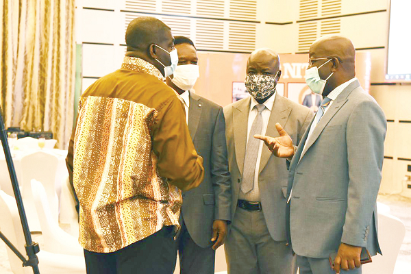 Dr John Ofori-Tenkorang (right), Director-General, SSNIT, interacting with Mr Alex Frempong (left), the Chief Executive Officer of the Ghana Employers Association; Mr Morgan Ayawine (2nd left), the General Secretary of the Industrial and Commercial Workers Union (ICU), and Mr Samuel Ayanga, the Deputy General Secretary in charge of Administration, ICU, just before the commencement of the meeting