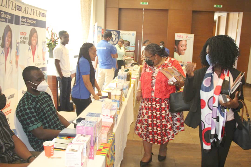 Dr Lydia Dsane-Selby, the Chief Executive officer of the NHIA (Arrowed), examining some of the products on display at a mini exhibition mounted by the local pharmaceutical companies