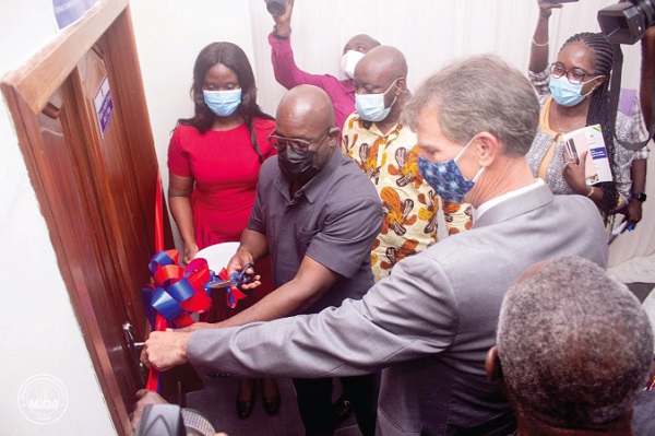 Mr Andrew Egyapa Mercer (middle), a Deputy Energy Minister, assisted by Mr Steve Marma (right), Resident Country Director, Millennium Challenge Corporation, cutting a tape to open the new meter management system