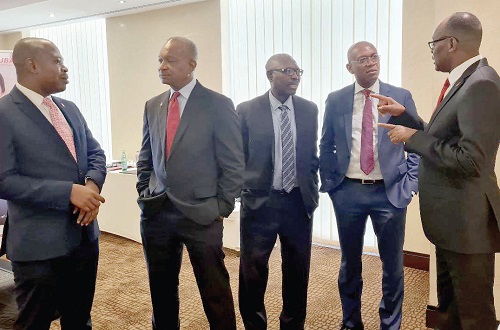 Chris Ofikulu (right),  Chief Executive Officer of UBA Ghana, interacting with some top executive members of the bank. With them is  Kweku Awotwi  (2nd from left), Chairman of the bank