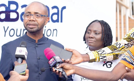 • John William Adel (left), President of KasaBazaar, speaking to the media after the launch. Looking on is Rose Adel, CEO of the company