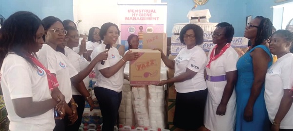 Solace A. M. Akomeah (4th from right), Secretary of WiWASH, handing over a box of sanitary pads to Mabel Adehenu  (3rd from right), Head of Human Resources, Ashaiman Municipal Education Directorate. Picture: BENJAMIN XORNAM GLOVER